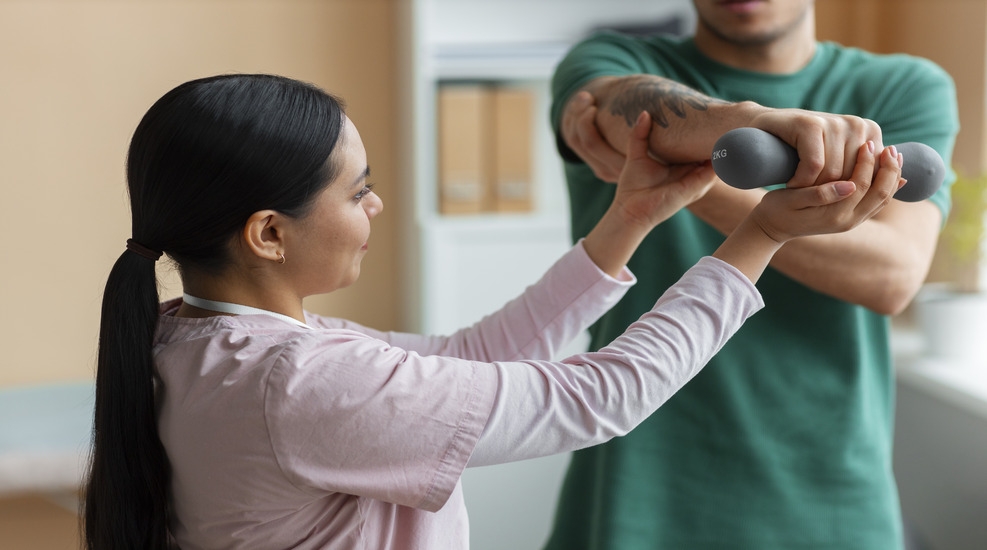 Physiotherapy session for cancer patient with therapist